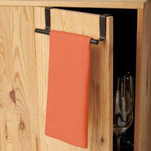 an orange background with a kitchen towel