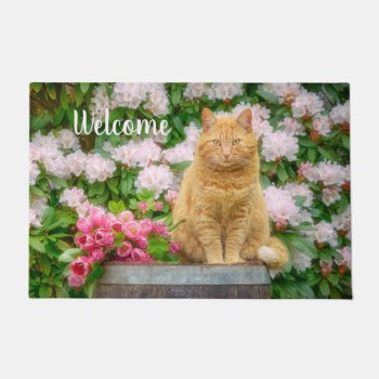 An Orange Cat In A Garden With Pink Spring Flowers Doormat by Kathom_Photo at Zazzle
