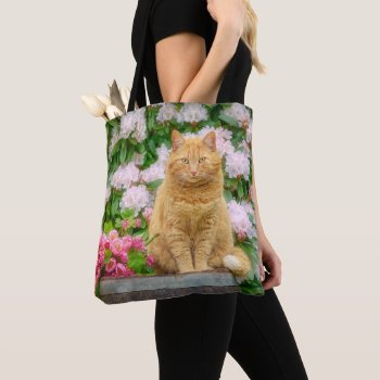 An Orange Cat In A Garden With Pink Spring Flowers Tote Bag by Kathom_Photo at Zazzle