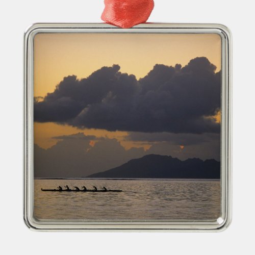 An outrigger canoe team practices off the coast metal ornament