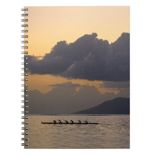 An outrigger canoe team practices off the coast notebook