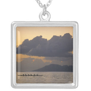 An outrigger canoe team practices off the coast silver plated necklace