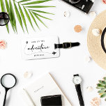 And So The Adventure Begins Black And White  Luggage Tag<br><div class="desc">Celebrate the beginning of your journey together with our "And So The Adventure Begins" Black and White Luggage Tag. These minimalist design luggage tags are perfect as a wedding or bridal shower favors, especially if you're embracing a honeymoon theme. Featuring elegant handwriting script and a modern aesthetic, they add a...</div>