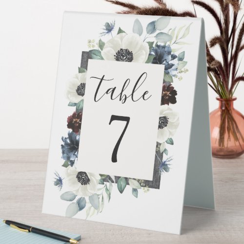 Anemone Navy Blue and Burgundy Boho Wedding Number Table Tent Sign - Design features elegant watercolor white anemone flowers, Scottish dusty blue thistle, burgundy and navy blue floral elements. Design also features various shades of blue and green greenery elements such as olive branch leaves, eucalyptus and more.