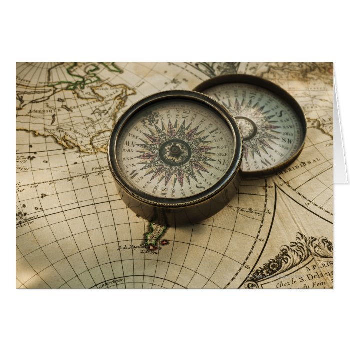 Antique compass on map card