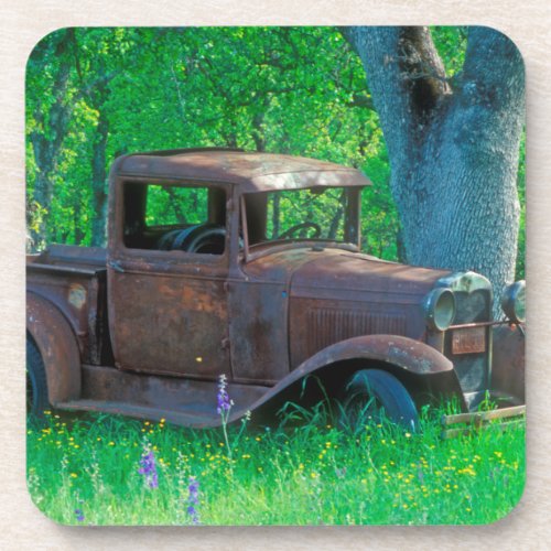 Antique rusted truck in a meadow coaster