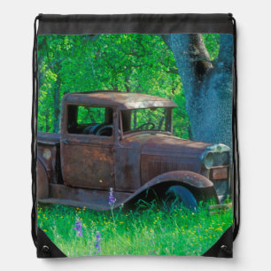 Antique rusted truck in a meadow drawstring bag