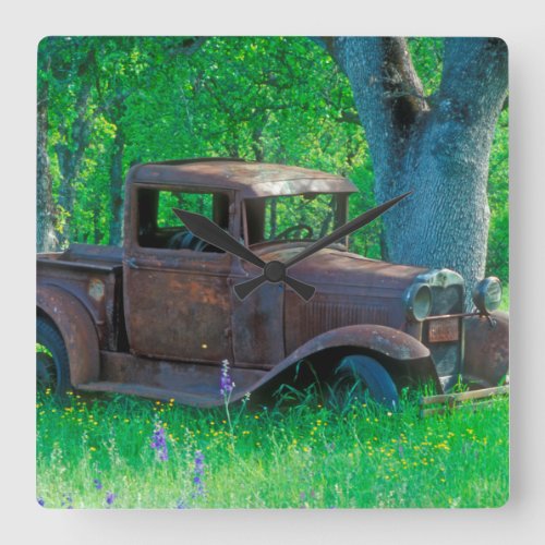 Antique rusted truck in a meadow square wall clock