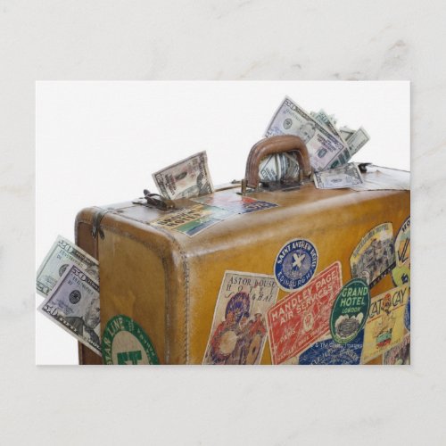 Antique suitcase with protruding money postcard