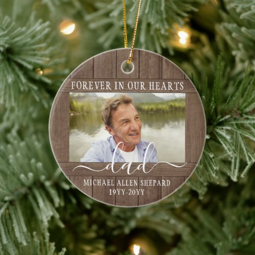 Any Text 2 Photo Memorial Simple Rustic Faux Wood Ceramic Ornament - Honor a departed loved one for the holidays with a custom photo faux wood round ceramic Christmas ornament. All text and images on this template are simple to personalize. "Forever in our hearts" can be changed to "in loving memory of," "an angel in heaven" or other wording. (IMAGE PLACEMENT TIP: An easy way to center a photo exactly how you want is to crop it before uploading to the Zazzle website.) The modern farmhouse style design features a rustic brown faux wood border, elegant handwritten style script calligraphy, typewriter typography name and years, and two images of your choice. This unique & modern sympathy keepsake makes a thoughtful funeral remembrance gift idea and adds a stylish touch to Xmas home decorations. It's an elegant way to pay tribute to a family member or friend who has passed away.