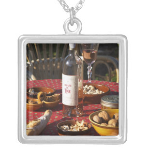 Aperitif and appetizers prepared: bread, olives, silver plated necklace