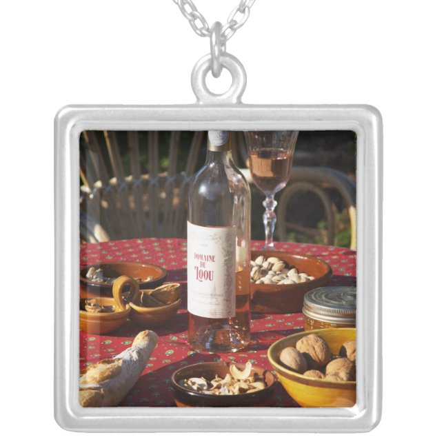 Aperitif and appetizers prepared: bread, olives, silver plated necklace (Front)
