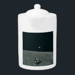 Apollo Lunar Lander and Earthrise Over Moon     Teapot<br><div class="desc">The cramped command module served as a temporary home, framing a breathtaking vista. In the foreground, the delicate spider-like Lunar Module dangled, awaiting its descent. Beyond it stretched the stark, cratered moonscape, its horizon curving dramatically. But stealing the show was Earth, a vibrant blue marble suspended in the black abyss,...</div>