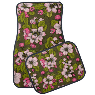Apple blossom on dark green car floor mat