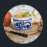 Applesauce with cinnamon in stoneware bowl dartboard with darts<br><div class="desc">Dart Board</div>