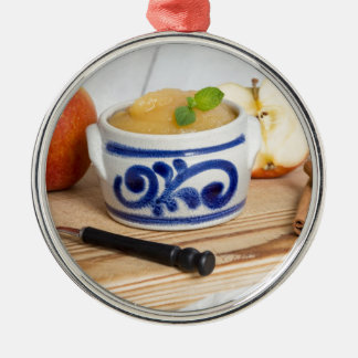 Applesauce with cinnamon in stoneware bowl metal ornament
