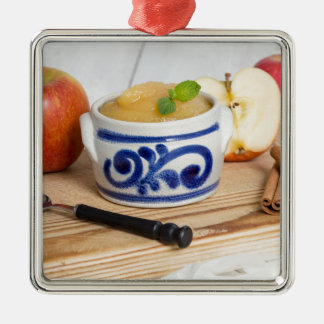 Applesauce with cinnamon in stoneware bowl metal ornament