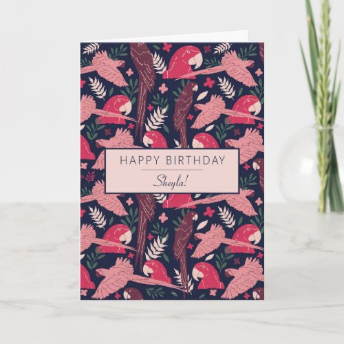 Ara Parrot Pink Tropical Leave Pattern Birthday Card - Ara Parrot Pink Tropical Leave Pattern Birthday Card. Ara pattern on dark blue background with tropical leaves and flowers in green, red and beige colors. Happy birthday text and name on the front - add your name. Add your message inside or erase it.