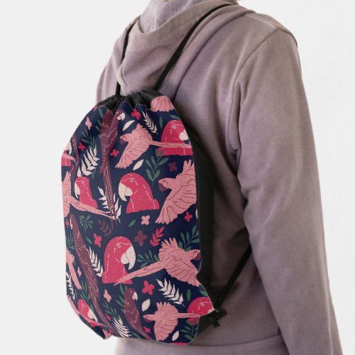 Ara Parrot Red Pink Drawing Tropical Leave Pattern Drawstring Bag - Ara Parrot Red Pink Drawing Tropical Leave Pattern Drawstring bag. Ara pattern on dark blue background with tropical leaves in green, red and beige colors. Digital hand-drawn illustration.