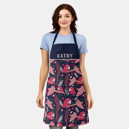 Ara Parrot Red Pink Tropical Leaf Pattern Name Apron - Ara Parrot Red Pink Tropical Leaf Pattern Name Apron. Ara pattern on dark blue background with tropical leaves in green, red and beige colors. Digital hand-drawn illustration. Add your name, any text or erase it.