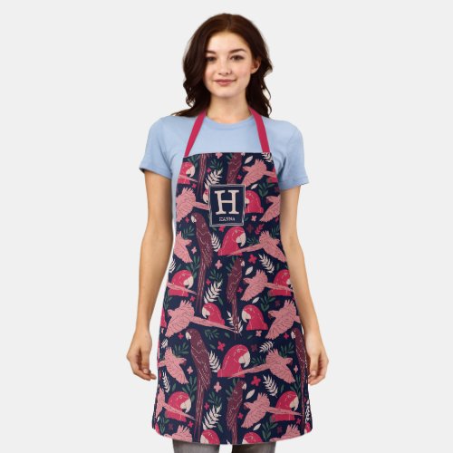 Ara Parrot Red Tropical Leaf Pattern Monogram Apron - Ara Parrot Red Tropical Leaf Pattern Monogram Apron. Red and burgundy ara parrots in a pattern on dark blue background with tropical leaves. Add your name and monogram.