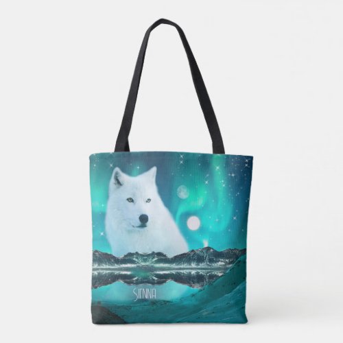 Arctic wolf and magical night with northern lights tote bag