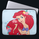 Ariel Ocean Beauty Bloom Laptop Sleeve<br><div class="desc">Let your style blossom under the sea with this radiant design of Ariel looking dazzling and dreamy! Surrounded by vibrant tropical flowers and glimmering bubbles, Ariel’s flowing red hair steals the spotlight—decorated with seashells, starfish, and plenty of sparkle. This charming illustration is perfect for fans who adore Ariel’s playful elegance...</div>