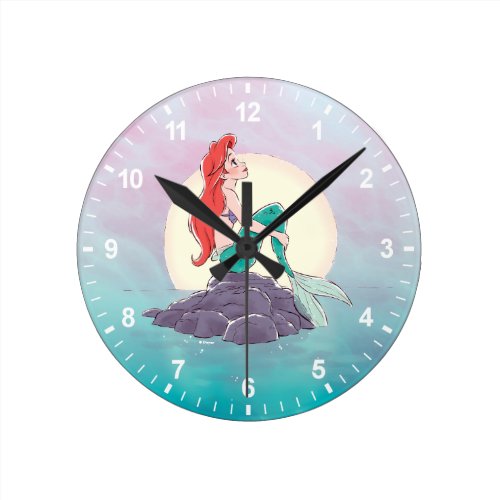 Ariel | The Little Mermaid - Pearlescent Princess Round Clock - Mermaids have more fun! This graphic features your favorite free-spirited Disney Princess, Ariel  with a beautiful watercolor sea background.