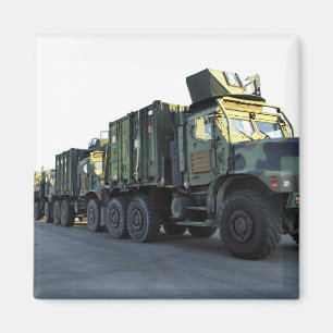 Armored trucks sit on the pier at Morehead City Magnet