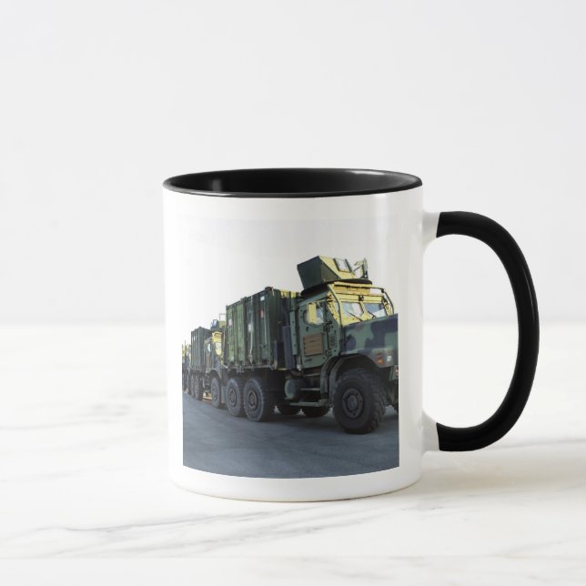 Armored trucks sit on the pier at Morehead City Mug (Right)