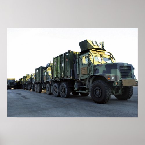 Armored trucks sit on the pier at Morehead City Poster
