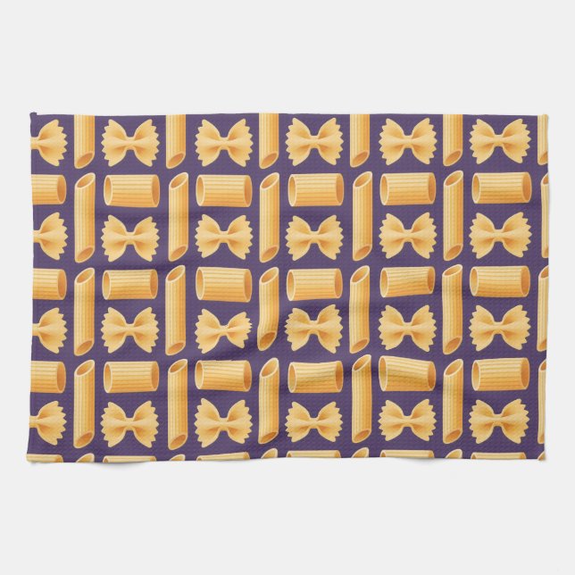 Array of various pasta shapes on a purple kitchen towel (Horizontal)