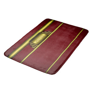 Art deco monogram on luxury gold and maroon bath mat