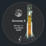 Artemis II Moon Mission Classic Round Sticker<br><div class="desc">This Artemis II mission marks to return of humankind to the vicinity of the Moon after a lapse of over 50 years. This 10 day mission will carry four astronauts on a free-return trajectory around the Moon and back to Earth. The spacecraft consists of the NASA SLS Space Launch System...</div>