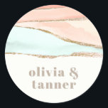 Artistic Coastal Watercolor Abstract Wedding Classic Round Sticker<br><div class="desc">With modern styling, this unique artistic wedding or engagement design features abstract painted watercolors in striated shades of adobe, peach, beige and mint green. Shimmering blond gold lines divide the layered colors to add beautiful detailing. The design is both simple and elegant with a minimalist look. The text colors include...</div>