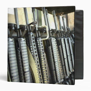 Assault rifles stand ready on the weapons rack 3 ring binder