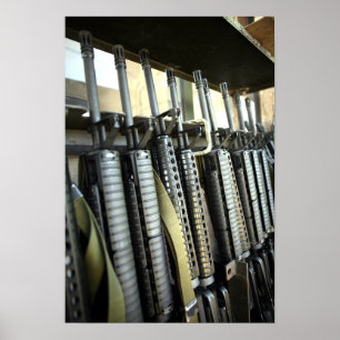 Assault rifles stand ready on the weapons rack poster