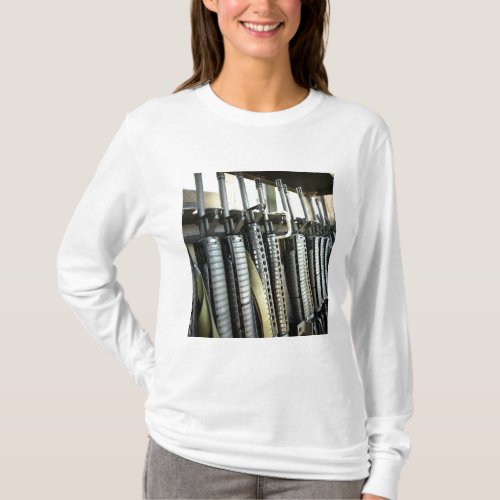 Assault rifles stand ready on the weapons rack T_Shirt