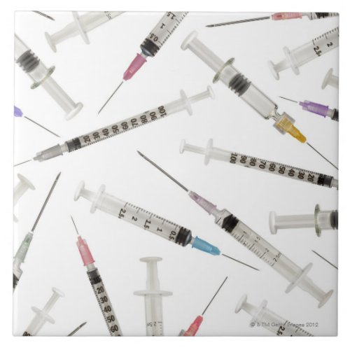 Assortment of syringes in various sizes and ceramic tile