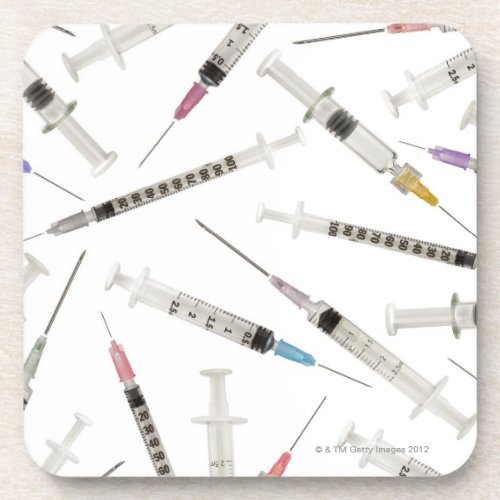 Assortment of syringes in various sizes and coaster