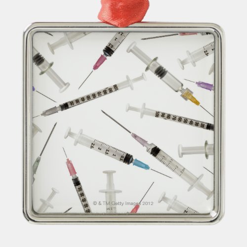 Assortment of syringes in various sizes and metal ornament