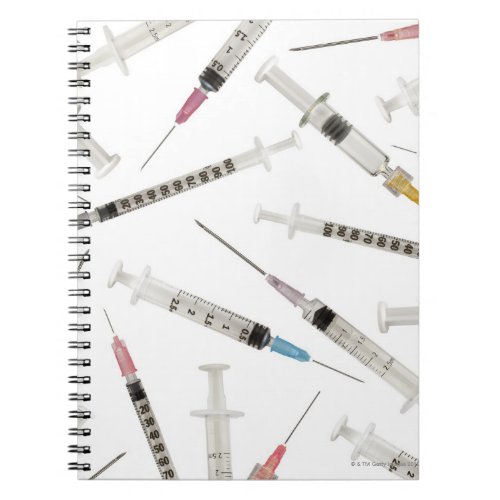 Assortment of syringes in various sizes and notebook