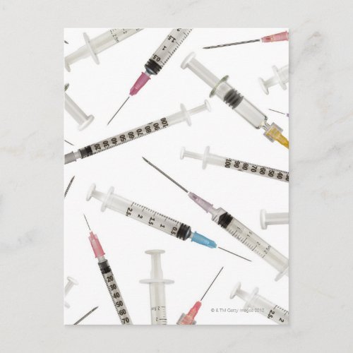 Assortment of syringes in various sizes and postcard