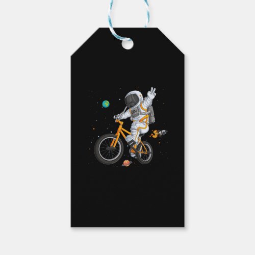astronaut in spacesuit riding bmx bike on space ov gift tags