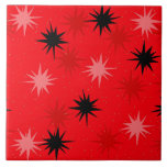 Atomic Red Starbursts Ceramic Tile<br><div class="desc">This Atomic Red Starbursts Ceramic Tile has all of the mid century modern fun of your grandma’s kitchen, minus the sticky linoleum. The kitschy design features a red background with gold speckles and randomly placed starbursts in black, and shades of red and dark pink. This vintage inspired pattern is mod...</div>