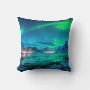 Aurora borealis over the sea coast, snowy mountain throw pillow
