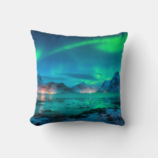 Aurora borealis over the sea coast, snowy mountain throw pillow