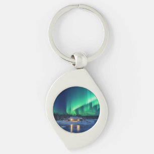 Aurora borealis over winter cabin keychain