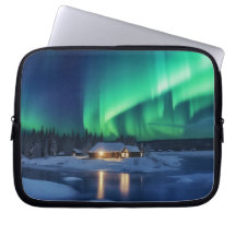 Aurora borealis over winter cabin
