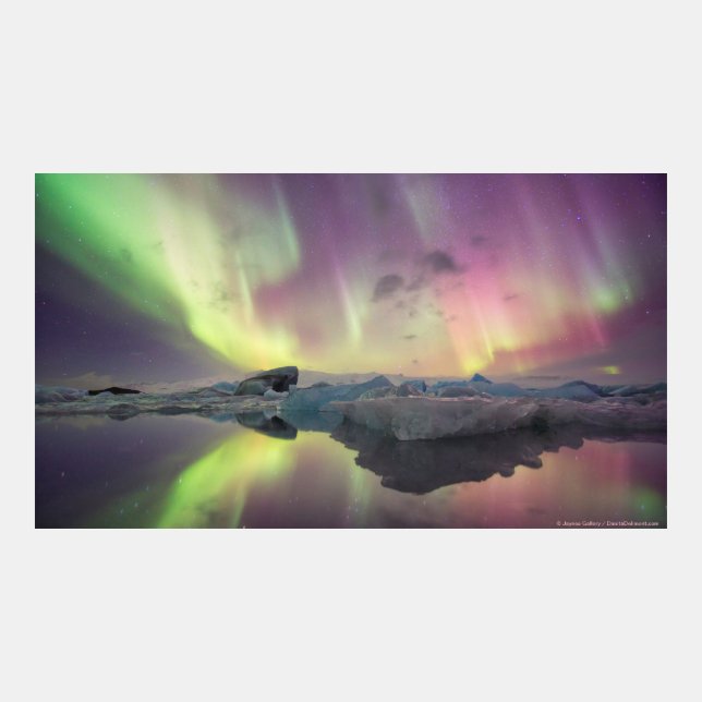 Aurora lights reflect in lagoon - Iceland